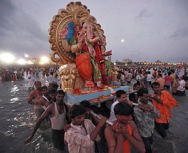 Devotees carry an idol of Ganesh, the deity of prosperity, for immersion in the sea