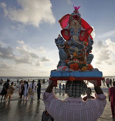 Devotees carry a Ganesh idol to immerse it in the waters of the Arabian Sea