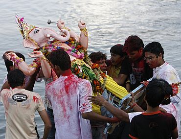 Devotees immerse an idol of Lord Ganesha