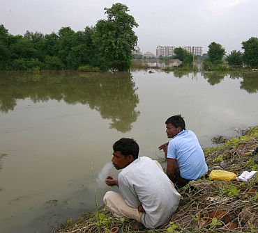 Local residents living on the banks of river Yamuna are pictured near the athletes village of the 2010 Commonwealth Games in New Delhi