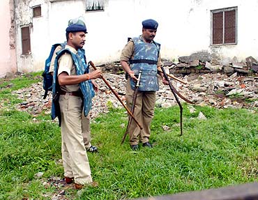 City Superintendent of Police, Ratlam,  Mahendra Tarnekar, right, inspects swords recovered