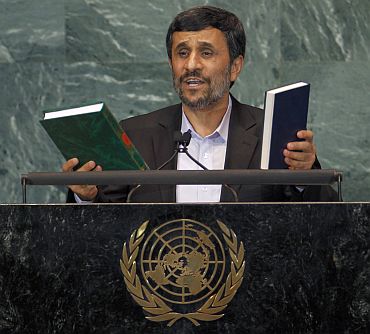 Ahmadinejad holds up copies of the Koran and the Bible while addressing the 65th United Nations General Assembly