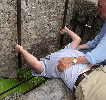 A man kisses the Blarney Stone