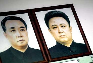 Portraits of North Korea's founder and Kim Il-sung (L) and his son and current leader Kim Jong-il are hung at an observation post in Seoul