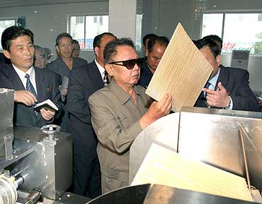 North Korean leader Kim Jong-il visits the Pyongyang Cornstarch Factory in this undated picture
