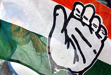 A cut out of Indian Prime Minister Manmohan Singh, seen through the Congress flag