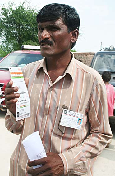 Mali Devidas Bhairas shows his card