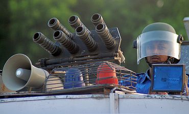 A Rapid Action Force trooper keeps guard atop his armoured vehicle in Allahabad