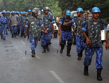 Rapid Action Force personnel patrol a road in Allahabad