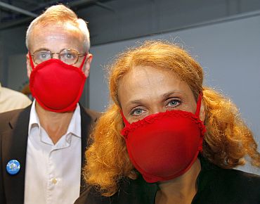 (R-L) Dr Elena Bodnar and John Durant, Director of the MIT Museum, demonstrate bras being worn as facemasks, at the MIT Museum in Cambridge, Massachusetts