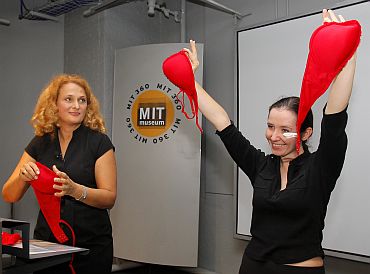 Dr Elena Bodnar watches as a volunteer holds up an 'Emergency Bra' after taking it off at the MIT Museum in Cambridge, Massachusetts