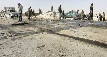 Police investigate a suicide blast site which killed the deputy governor of Afghanistan's Ghazni province