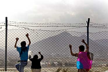 A boy and his friends look at a view in Kabul