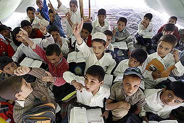 Afghan students study in a make-shift classroom