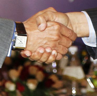 Home Secretary G K Pillai shakes hands with his Pakistani counterpart Chaudhary Qamar Zaman