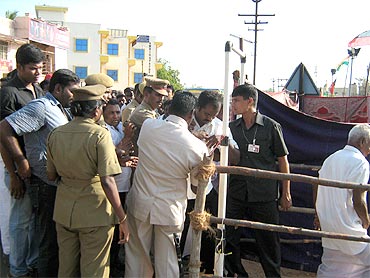 Security personnel conduct checks at the rally