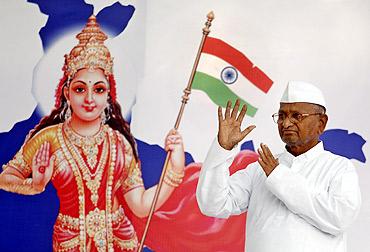 Social activist Anna Hazare waves to his supporters during his fast-unto-death campaign in New Delhi