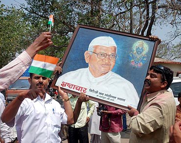 People in Ralegan Siddhi celebrate after Anna Hazare decides to break his fast unto death against corruption on Saturday
