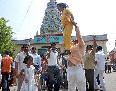 People in Ralegan Siddhi celebrate after Anna Hazare decides to break his fast unto death against corruption on Saturday