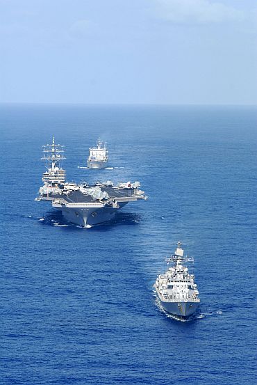 Aircraft carrier USS Ronald Reagan (CVN 76) and ships from Ronald Reagan Strike Group transit the Pacific Ocean in a nine ship formation with the Indian Navy