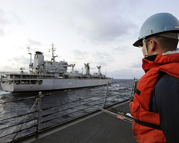 A Sailor attached to the guided-missile destroyer USS Stethem (DDG 63) watches as the Indian fuel tanker INS Jyoti (A 58) pulls alongside during a simulated replenishment-at-sea operation as part of exercise Malabar 2011