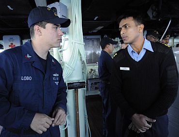 Indian Navy Liaison Officer LT K Srinivasan speaks with Quartermaster 1st Class Carlos Lobo about bridge wing operations aboard the guided-missile destroyer USS Stethem (DDG 63), as part of exercise Malabar 2011