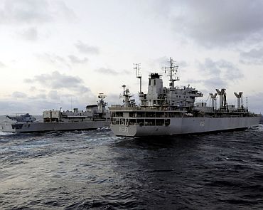 The Indian navy fuel tanker INS Jyoti (A 58) and guided-missile destroyer INS Delhi (D 61) sail side-by-side as part of exercise Malabar 2011