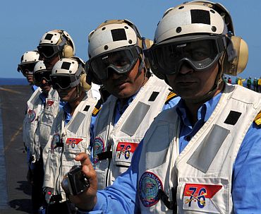 Rear Adm Robert Girrier, commander of Carrier Strike Group 7, observes flight operations on board the aircraft carrier USS Ronald Reagan's (CVN 76) with Indian naval officers