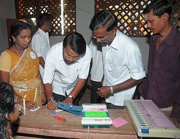 Polling officials checking the Electronic Voting Machines and other necessary inputs required for the assembly election