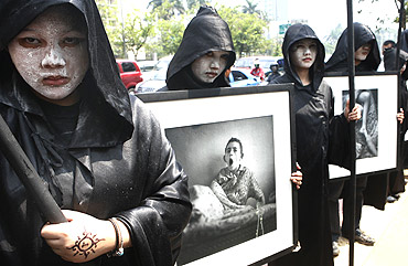 Environmental activists hold portraits of the victims of the Chernobyl nuclear disaster during an anti-nuclear protest