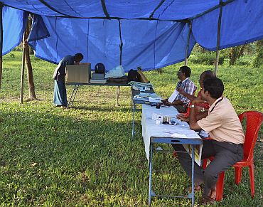 A man casts his vote at a temporary polling booth on Ramanthuruthu Island during the state assembly election in Kerala on April 13