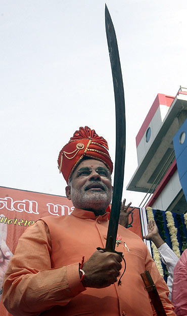 Narendra Modi holds a sword before filing his nomination papers for the 2007 assembly elections in Ahmedabad