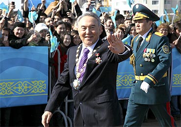 Kazakh President Nursultan Nazarbayev waves to supporters