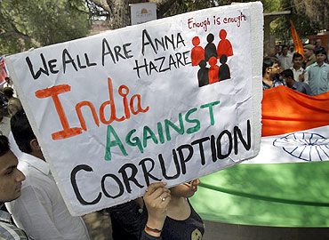A supporter of social activist Anna Hazare holds up a sign during a campaign against corruption in New Delhi