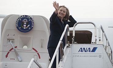 US Secretary of State Hillary Clinton waves prior to departing Haneda Airport in Tokyo