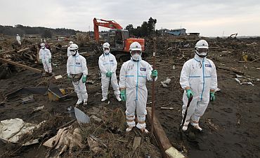 Police officers in protective suits near Fukushima