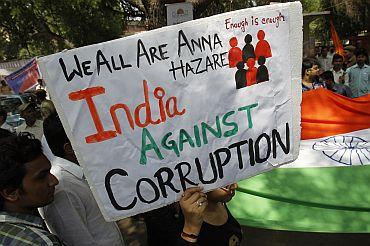 A supporter of social activist Anna Hazare holds up a sign