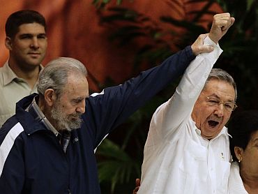 Former Cuban leader Fidel Castro with his brother, Cuba's President Raul Castro, during the closing ceremony of the sixth Cuban Communist Party congress in Havana