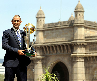 India's captain Mahendra Singh Dhoni lifts the trophy at the Taj hotel