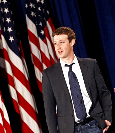 Facebook CEO Mark Zuckerberg arrives for the start of a town hall meeting with U.S. President Barack