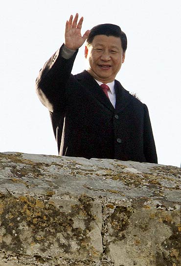 China's Vice President Xi Jinping waves to photographers as he visits the Bellver Castle in Spain