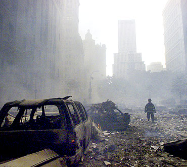 A firefighter walks amid rubble near the base of the destroyed World Trade Centre on Sept 11, 2001