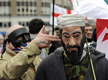 A man wears an Osama bin Laden mask during a rally