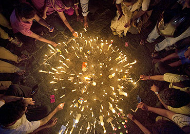 Demonstrators light candles in front of the Gateway of India during a campaign against corruption in Mumbai