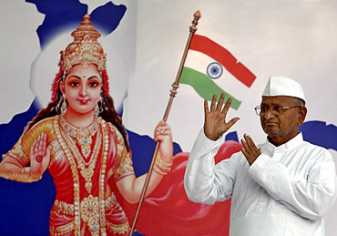 Social activist Anna Hazare waves to his supporters during his campaign in New Delhi