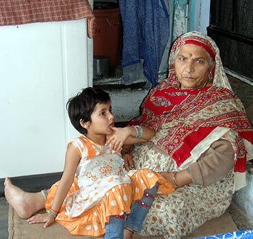 Ravi Below's mother and her grandchild. Three generation share their small camp home.