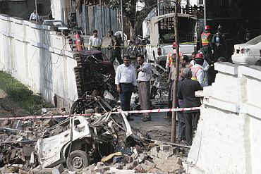 Officials survey the site where a suicide bomber killed at least six people and wounded 19 in an attack on a Pakistan naval college in Lahore in May, 2008.