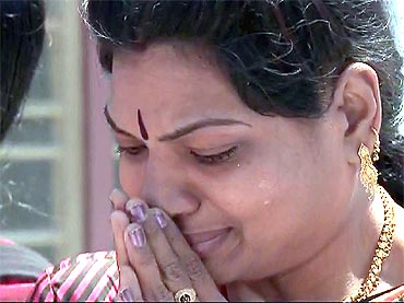 A devotee weeps as Sai Baba's last rites were performed in Puttaparthy on Wednesday