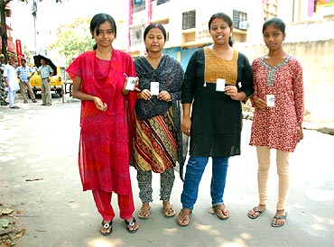 First-time voters proudly flaunt their voter idendity cards