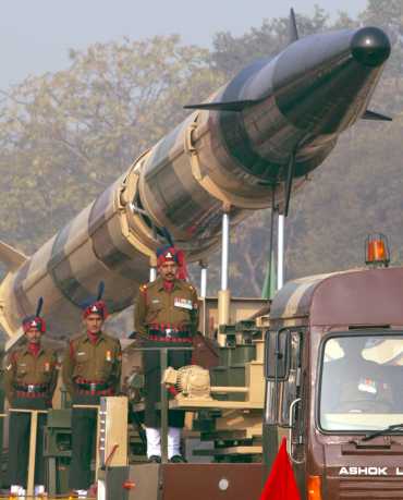 Soldiers stand alongside the Agni-2 missile
